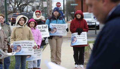 
              In this March 8, 2011 photo, anti-abortion protesters gather outside the Hope Clinic for Women in Granite City, Ill., as Rev. Chris Comerford, right, from St. Elizabeth